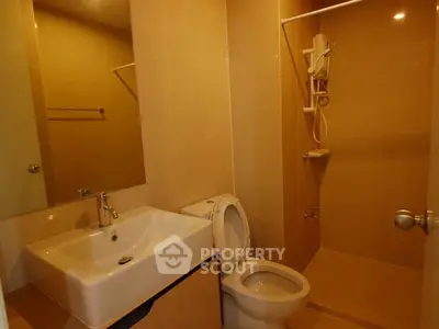 Modern bathroom with sleek fixtures and a spacious shower area in a contemporary apartment.