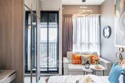 Modern bedroom with balcony view, stylish decor, and cozy seating area.