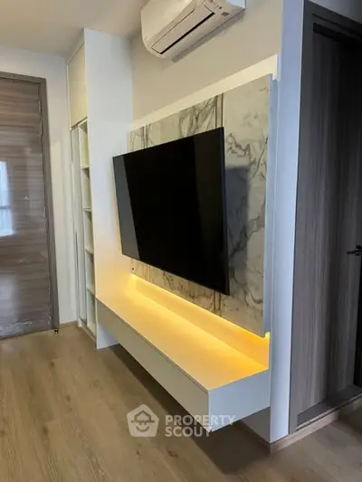 Modern living room with wall-mounted TV and ambient lighting