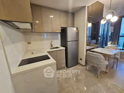 Modern kitchen with sleek cabinetry and dining area in a stylish apartment
