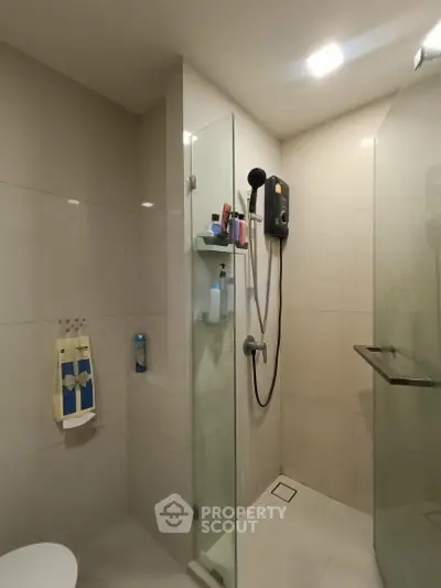 Modern bathroom with glass shower enclosure and sleek fixtures