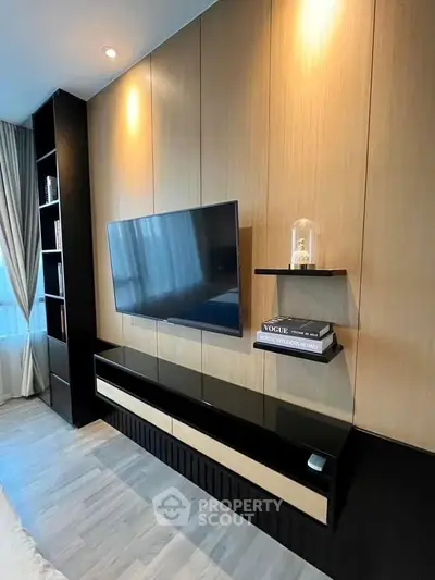 Modern living room with sleek TV setup and stylish shelving