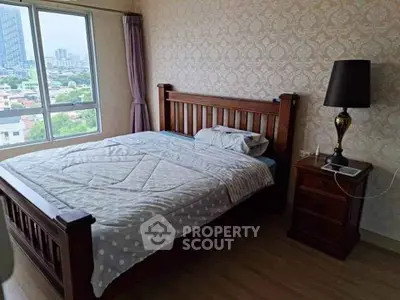 Cozy bedroom with wooden bed frame and city view window in modern apartment.