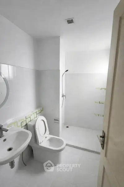 Modern minimalist bathroom with white tiles and walk-in shower