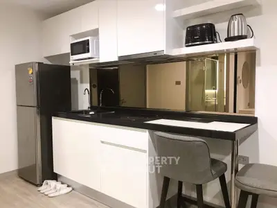 Modern kitchen with sleek white cabinets and stainless steel appliances