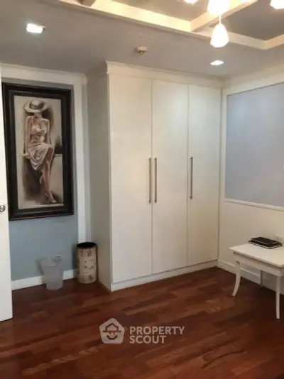 Elegant bedroom with wooden flooring and stylish wardrobe