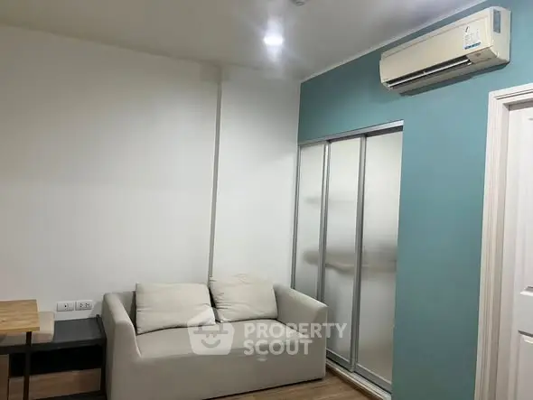 Modern living room with air conditioning and sliding door closet