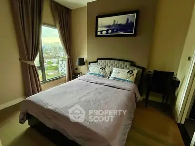 Cozy bedroom with city view, elegant decor, and natural light.