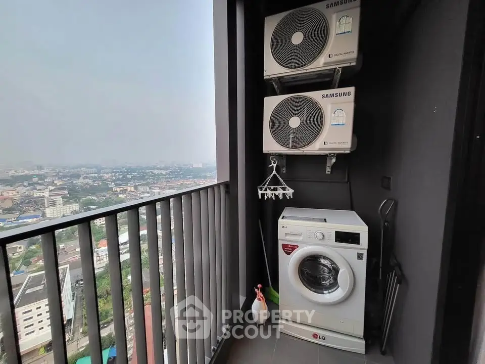 High-rise balcony with washing machine and city view