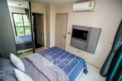 Modern bedroom with air conditioning and balcony view in a stylish apartment.