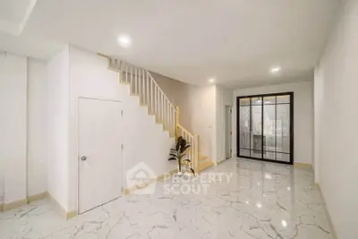 Spacious modern interior with marble flooring and elegant staircase