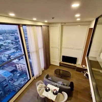 Stunning high-rise living room with panoramic city views and elegant decor.