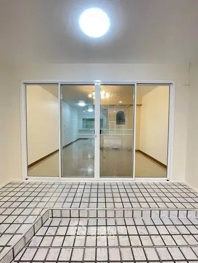 Spacious interior with sliding glass doors and tiled flooring, ideal for modern living.