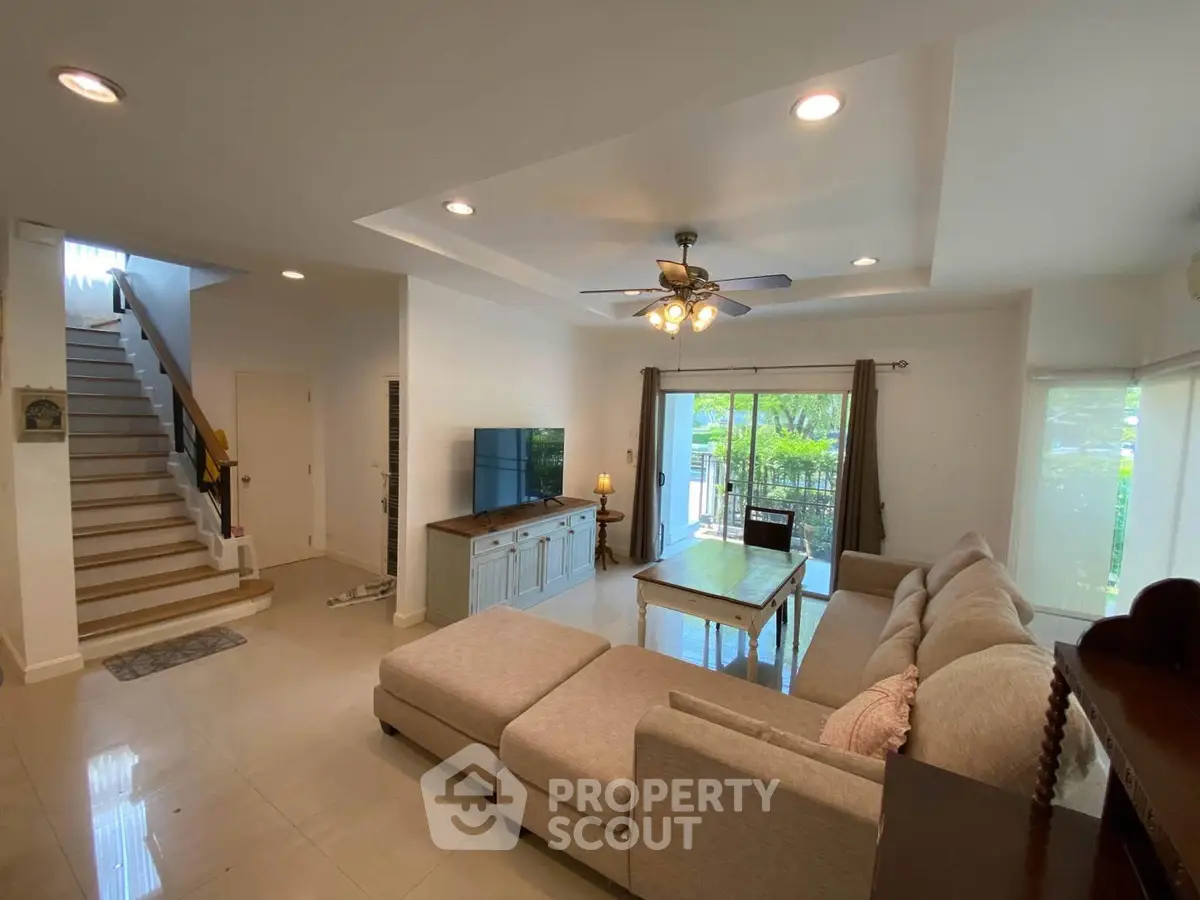 Spacious living room with modern decor and large windows for natural light