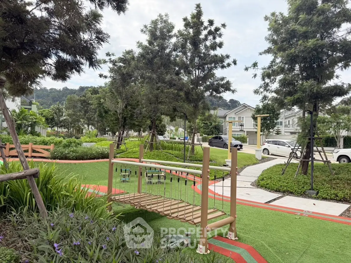 Charming residential garden with lush greenery and play area, perfect for family living.