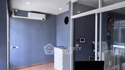 Modern study room with air conditioning and glass partition in sleek apartment.