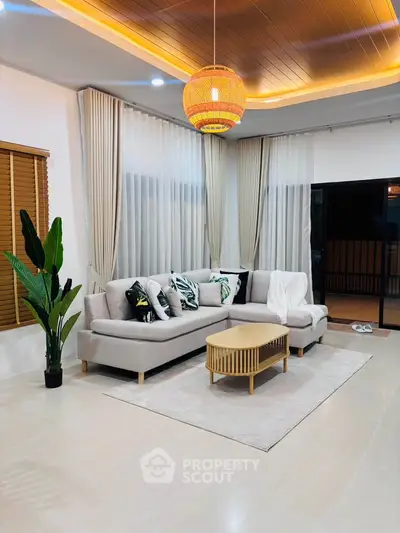 Elegant living room with modern decor, cozy sectional sofa, and ambient lighting for a warm atmosphere.