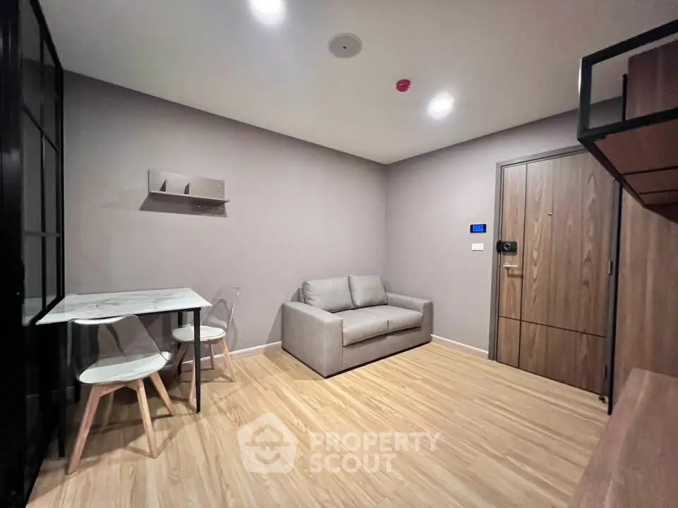 Modern living room with cozy sofa and dining area in stylish apartment