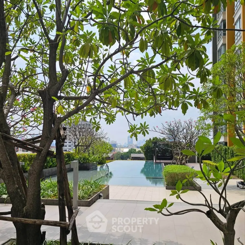 Luxurious residential pool area with lush greenery and city views, perfect for relaxation and leisure.