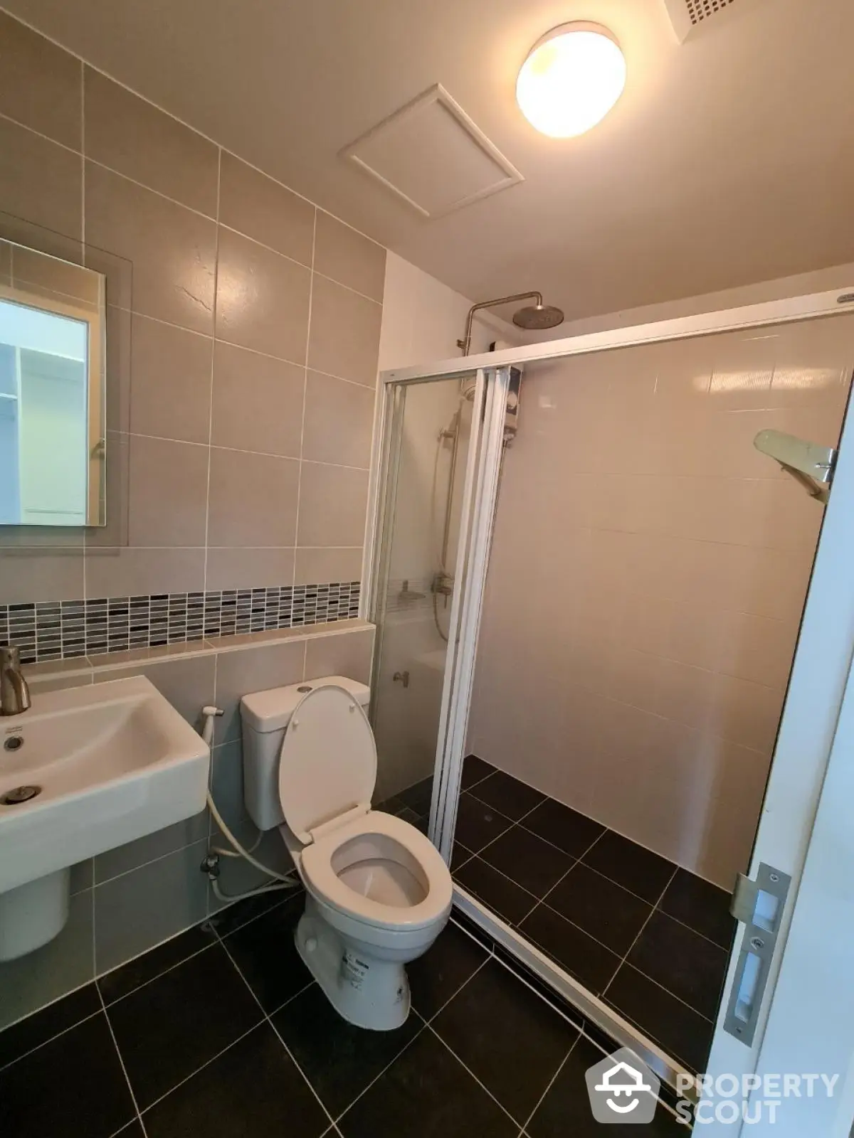 Modern bathroom with sleek tiles and glass shower enclosure