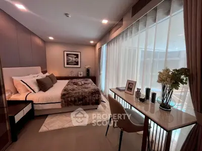 Luxurious bedroom with elegant decor and large window offering natural light.