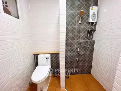 Modern bathroom with sleek white tiles and shower area