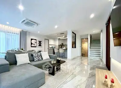 Spacious modern living room with open kitchen and elegant decor