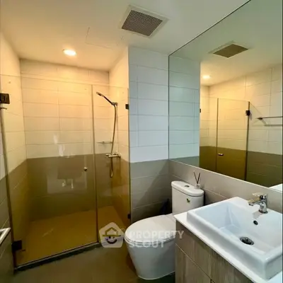 Modern bathroom with glass shower and sleek fixtures