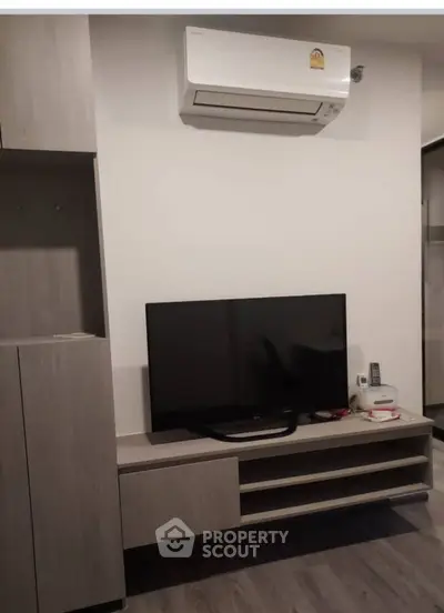 Modern living room with sleek TV unit and air conditioning