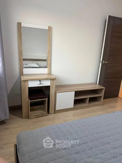 Modern bedroom with stylish wooden furniture and cozy bed setup