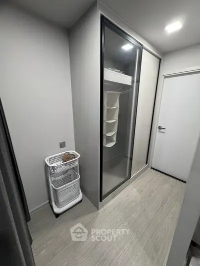 Modern storage area with sleek sliding door closet and minimalist design