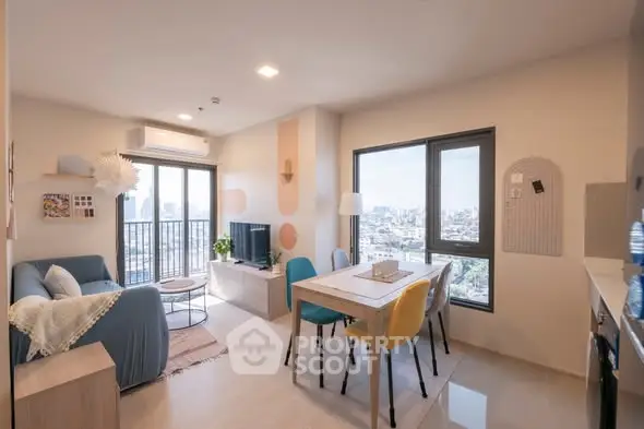 Modern living room with city view, stylish decor, and dining area in open layout apartment.