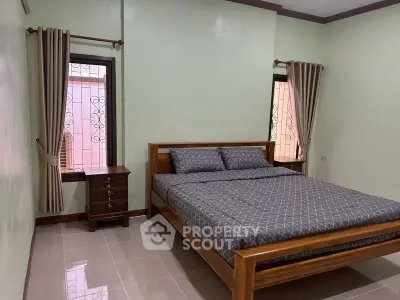 Cozy bedroom with wooden bed frame and elegant curtains