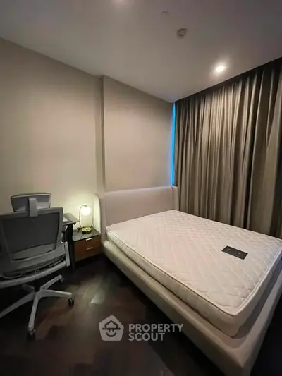Modern bedroom with cozy lighting and stylish furniture, perfect for relaxation and productivity.