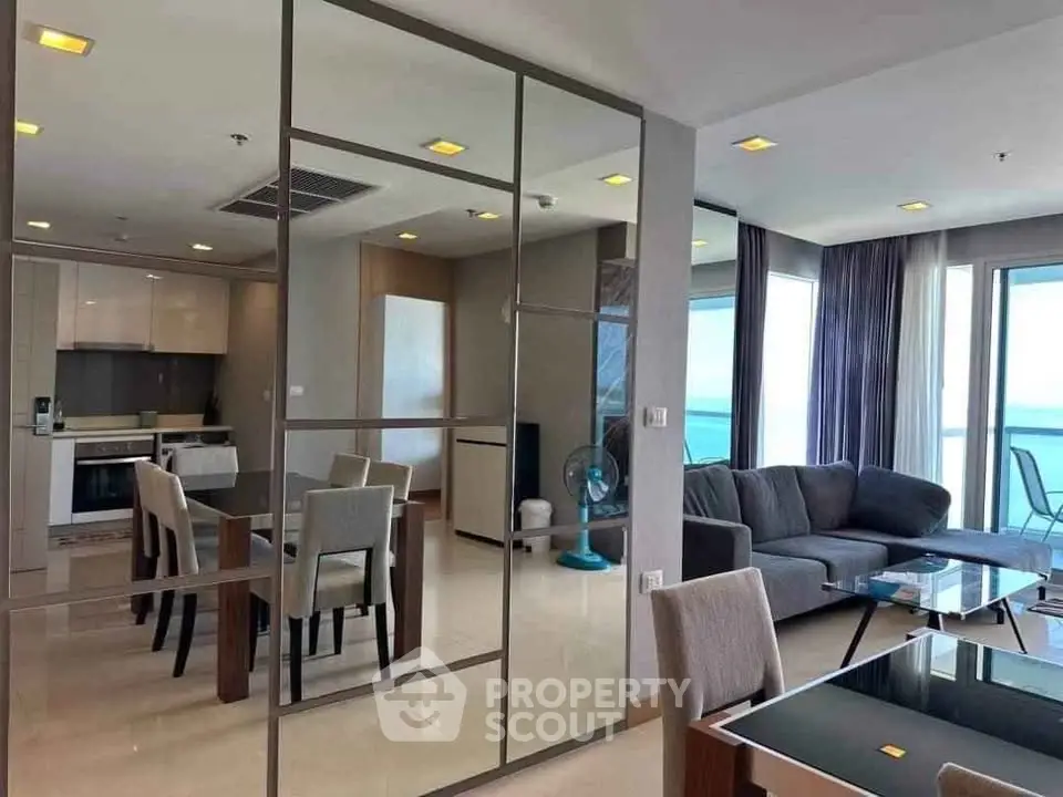 Luxurious modern living room with ocean view, open layout, and elegant furnishings.