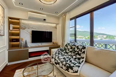 Luxurious living room with stunning mountain view, elegant decor, and modern entertainment setup.