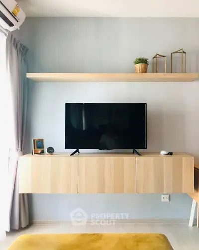 Modern living room with sleek TV setup and stylish wooden shelving