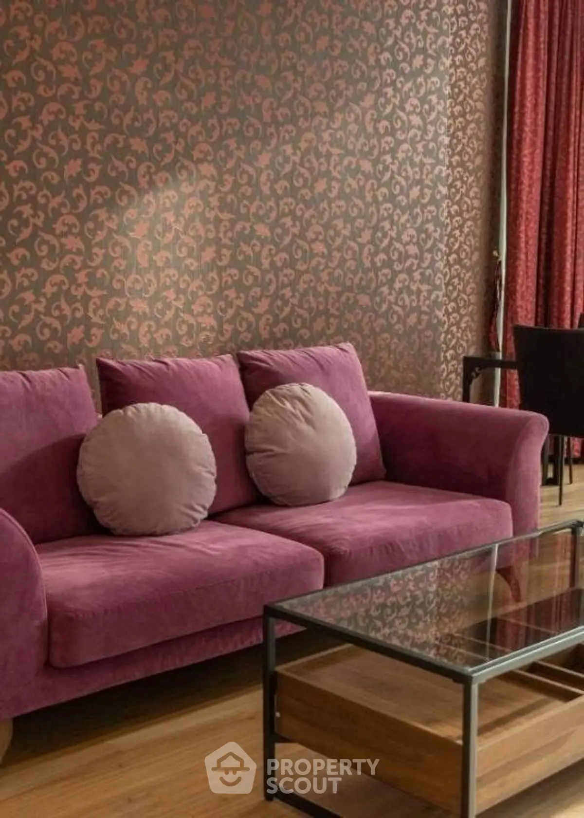 Stylish living room with purple sofa and elegant wallpaper, perfect for modern interiors.
