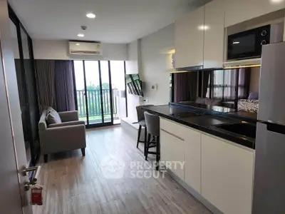 Modern open-layout living room with kitchen and balcony view