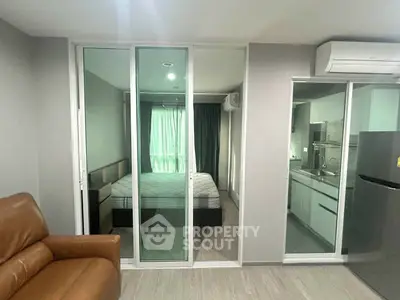 Modern apartment interior with bedroom and kitchen, featuring sleek design and comfortable furnishings.