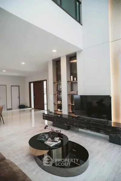 Luxurious modern living room with high ceilings and elegant decor