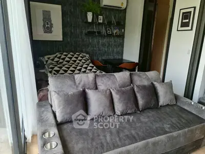 Modern living room with plush gray sofa and stylish decor in cozy apartment