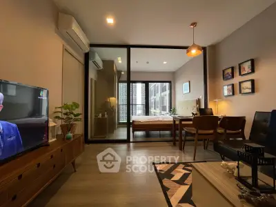 Modern living room with stylish decor and view into cozy bedroom