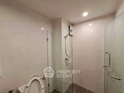 Modern bathroom with glass shower and sleek tile design