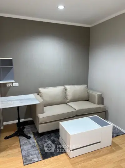 Cozy modern living room with beige sofa and sleek furniture