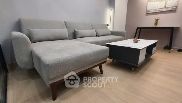 Modern living room with stylish gray sofa and sleek coffee table