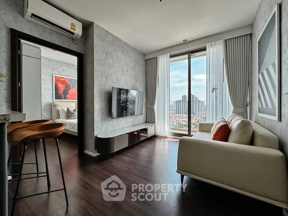 Modern living room with city view, stylish decor, and open layout in a high-rise apartment.