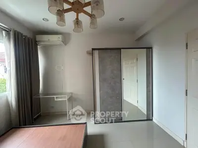 Modern bedroom with sleek wardrobe and stylish lighting fixture
