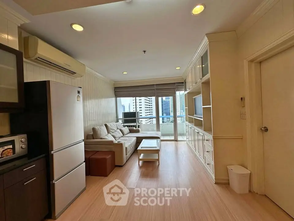 Spacious living room with modern furniture and city view, perfect for urban living.