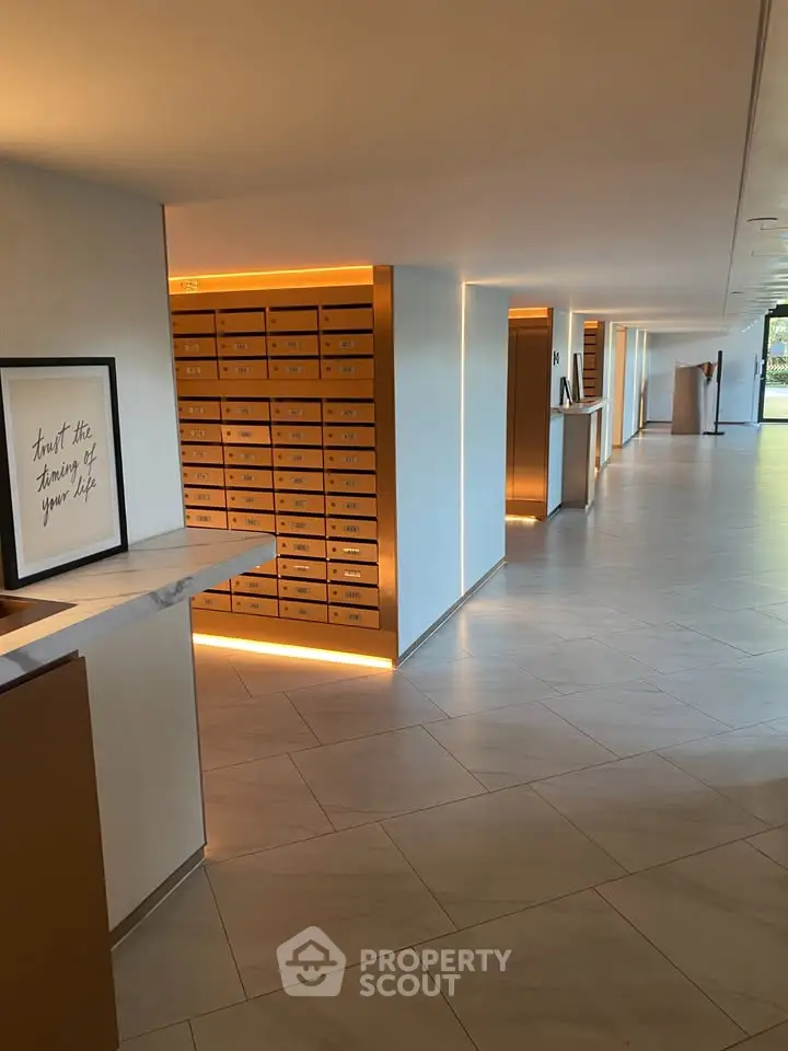 Modern apartment building entrance with stylish mailboxes and sleek design.